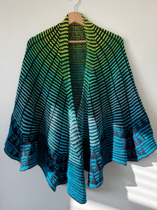 Knitted shawl with blue and green striped pattern on a white background